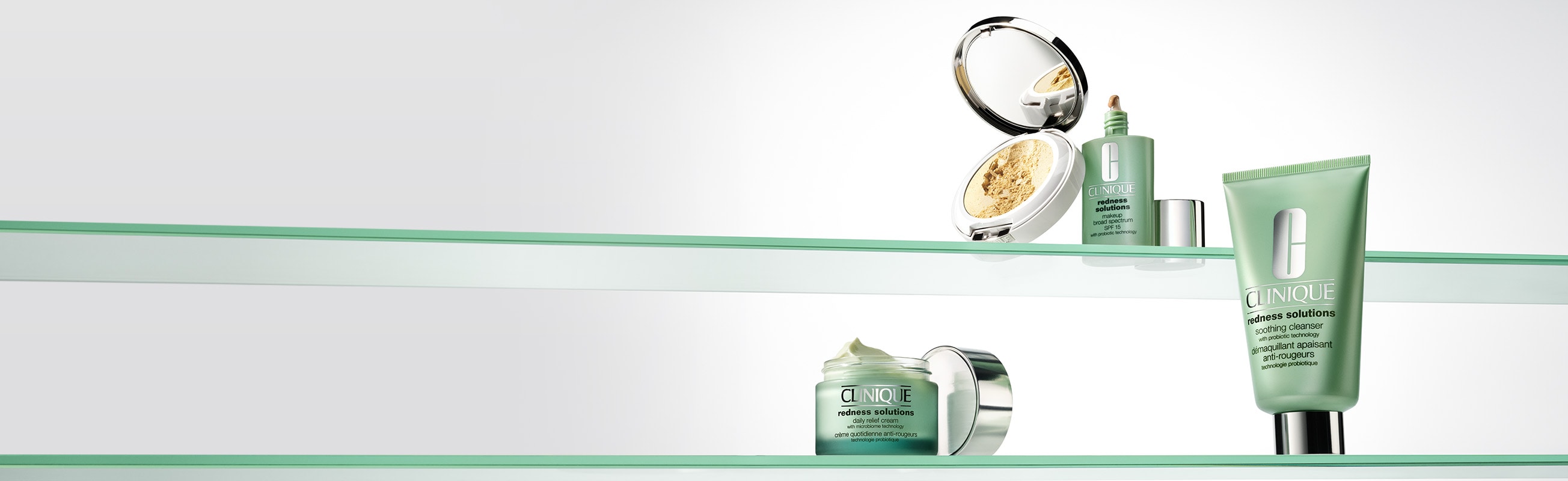 Selection of bestselling Clinique Redness™ products on a glass shell