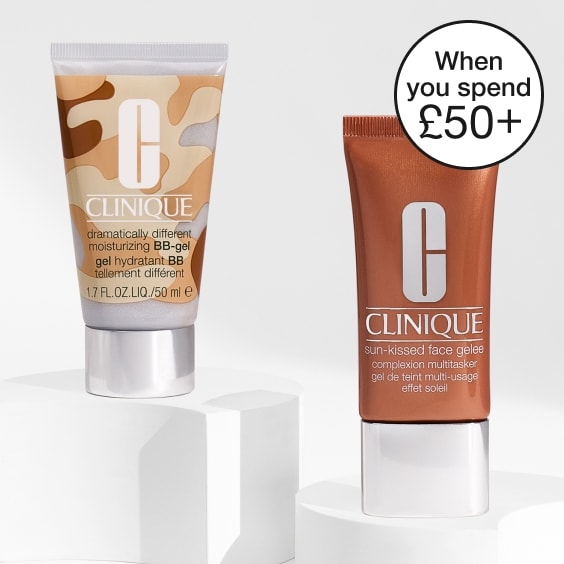 Spin for Clinique Treats randomizer in front of a bright orange background, with spider webs in the corners
