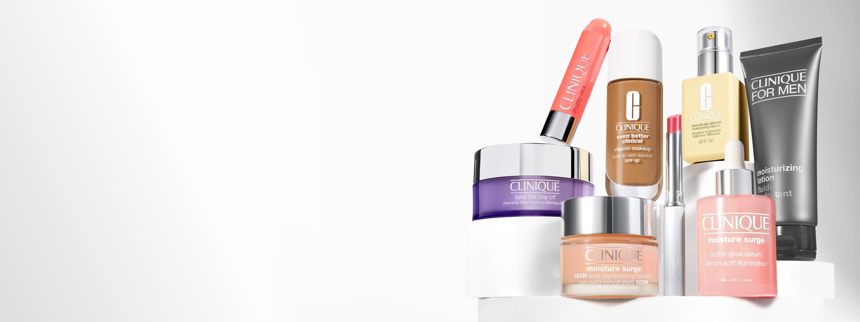 Selection of Clinique bestselling products on a grey podium, in a studio setting with bright lighting