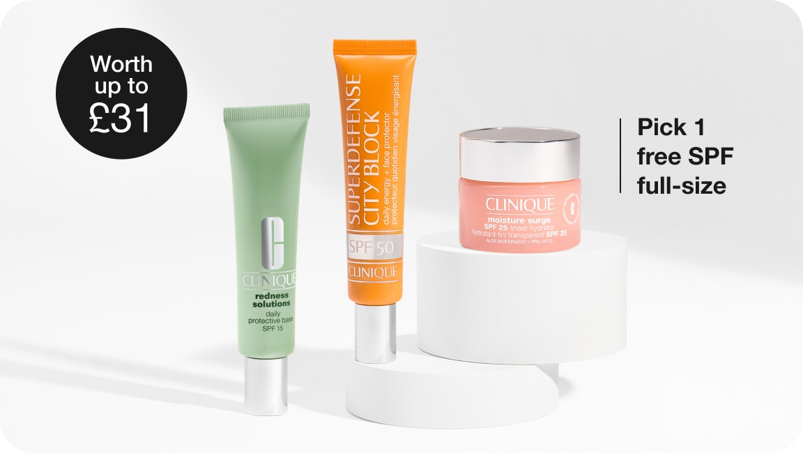 Selection of full-size Clinique products in front of a grey background, with black illustrated sparkles dotted around