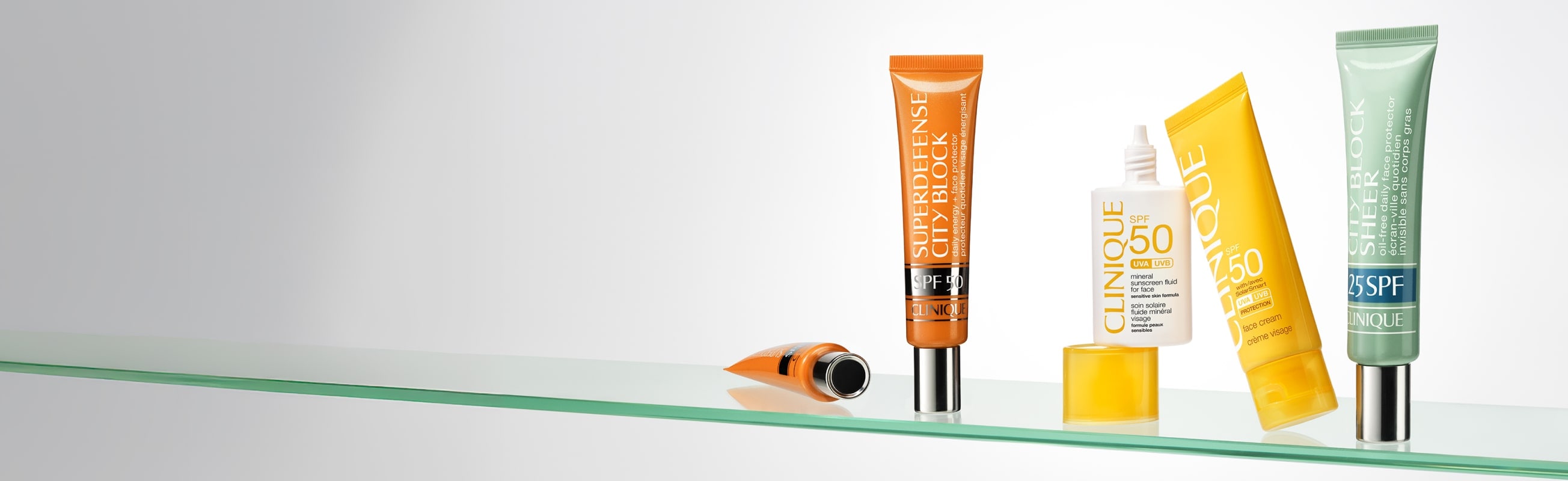 Selection of bestselling Clinique SPF products on a glass shell
