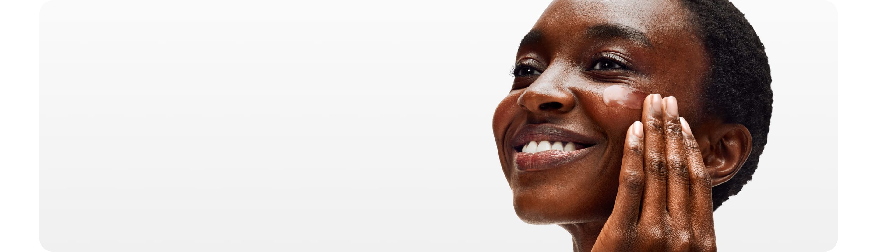 model rubbing her face with a moisturiser 