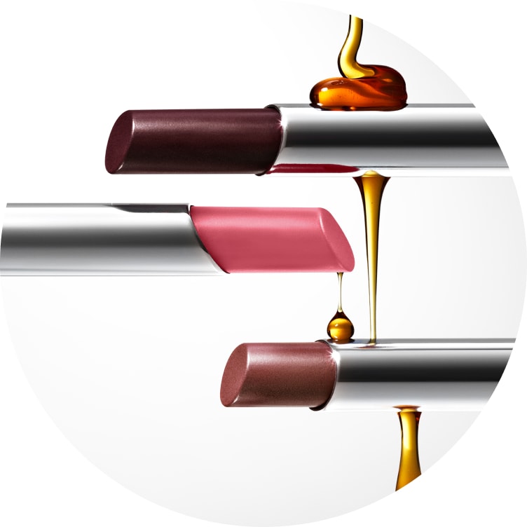 Clinique Almost Lipstick shown with its sheer tinted balm melting and layering onto the product.