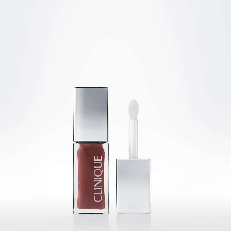 Clinique Lip + Cheek Oil shown in a clear bottle with a sheer tinted formula and its applicator.