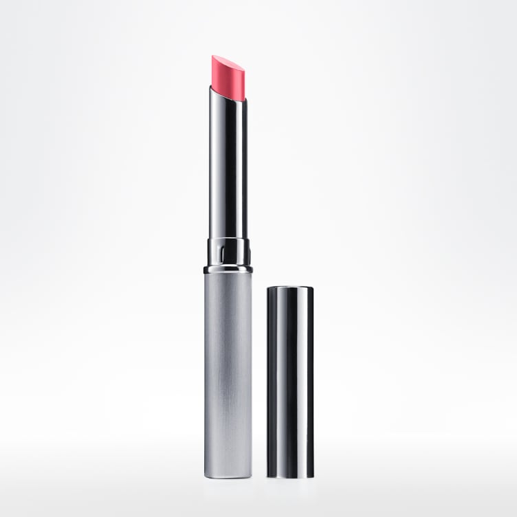 Silver tube of pink Almost Lipstick shown standing upright with its cap beside it.