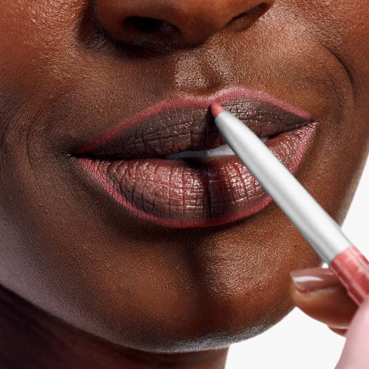 Close-up of lips wearing a defined berry shade created with Clinique’s Quickliner.