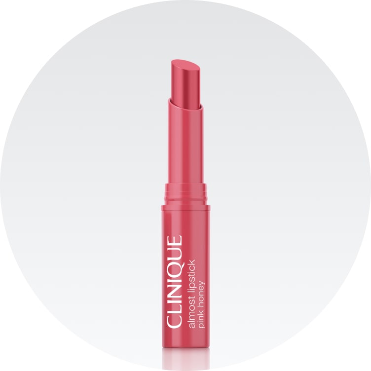 Almost lipstick mini in pink honey shade on a soft grey background
