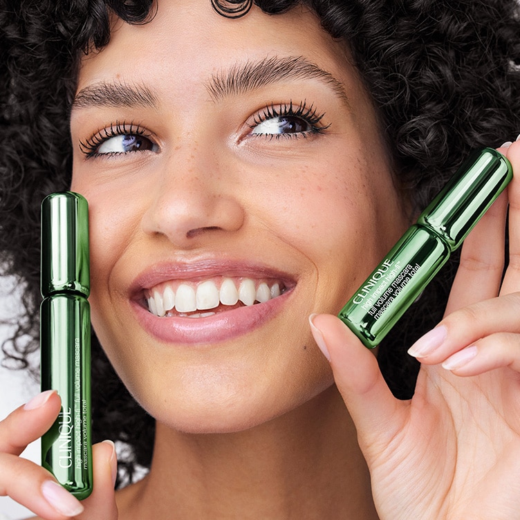 Selection of new brow and eye products dynamically placed on a glass shelf, in a brightly lit studio setting
