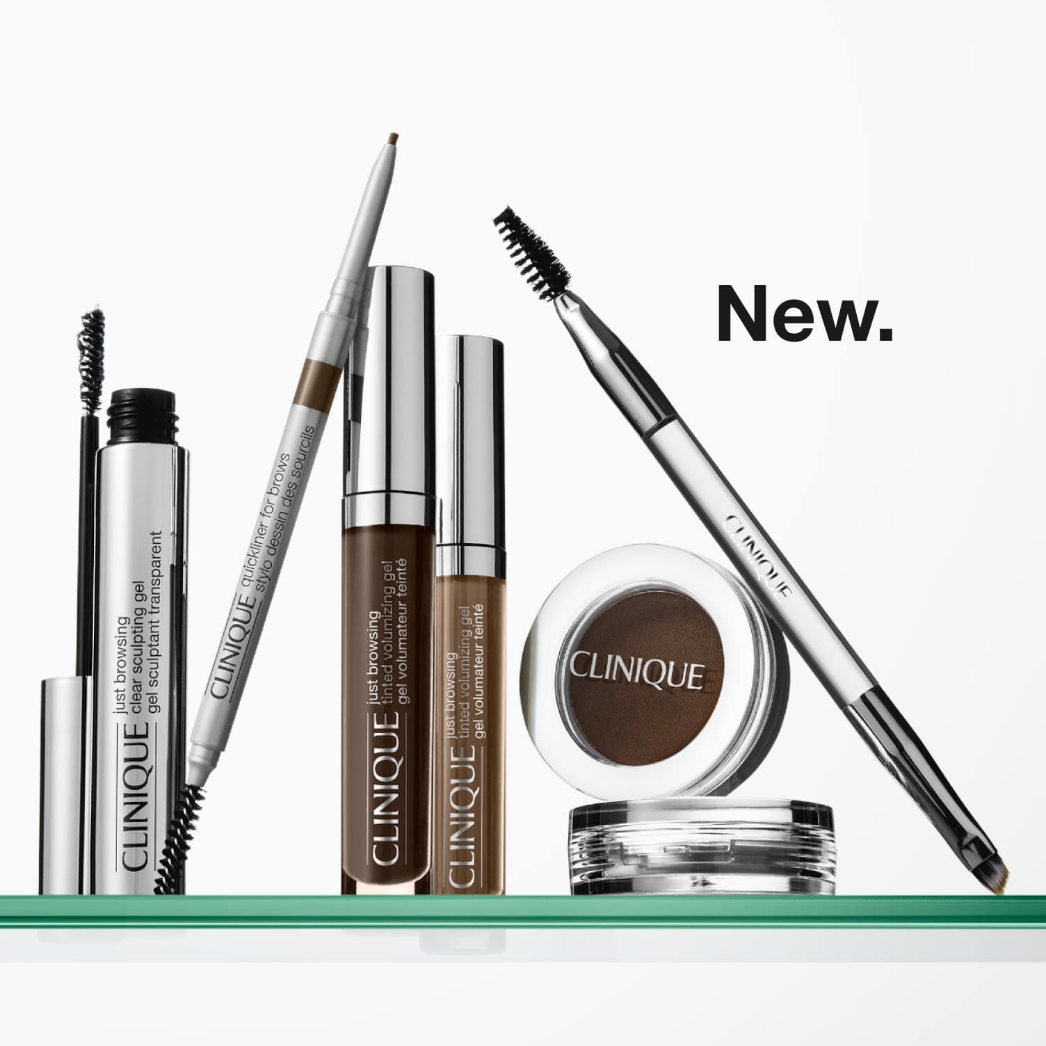 Selection of new brow and eye products dynamically placed on a glass shelf, in a brightly lit studio setting