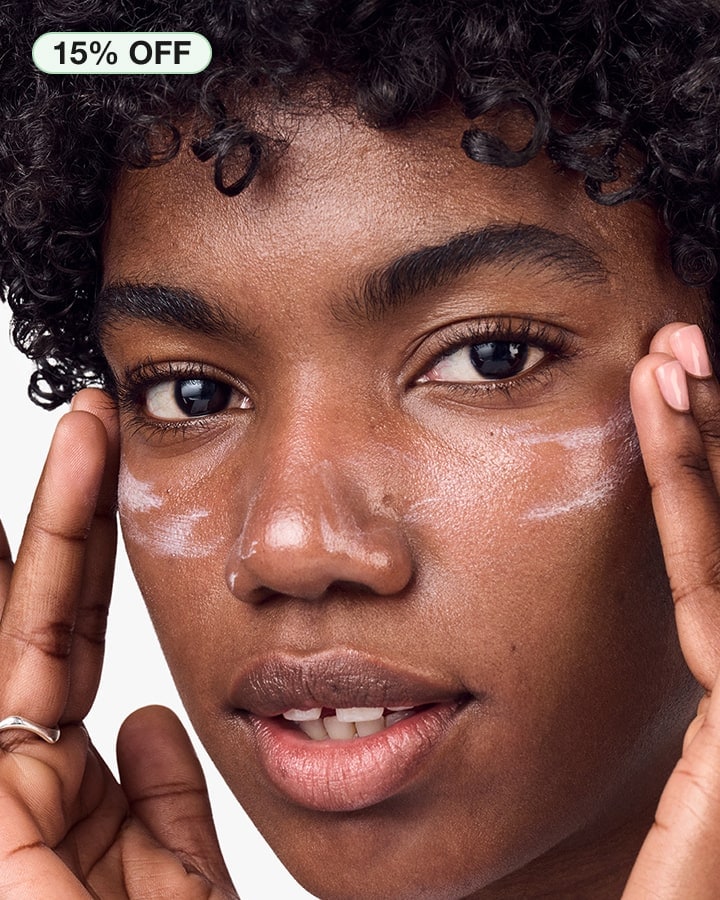 Close up of model applying Moisture Surge™ SPF 25 Sheer Hydrator to skin, focusing on product texture
