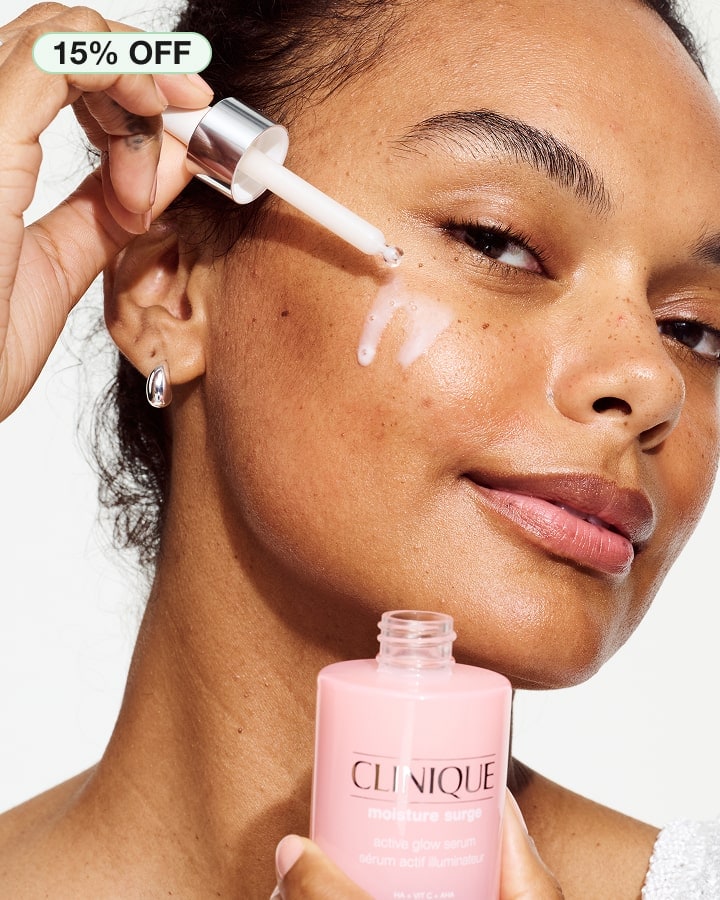Close up of model applying NEW Moisture Surge Active Glow Serum to skin