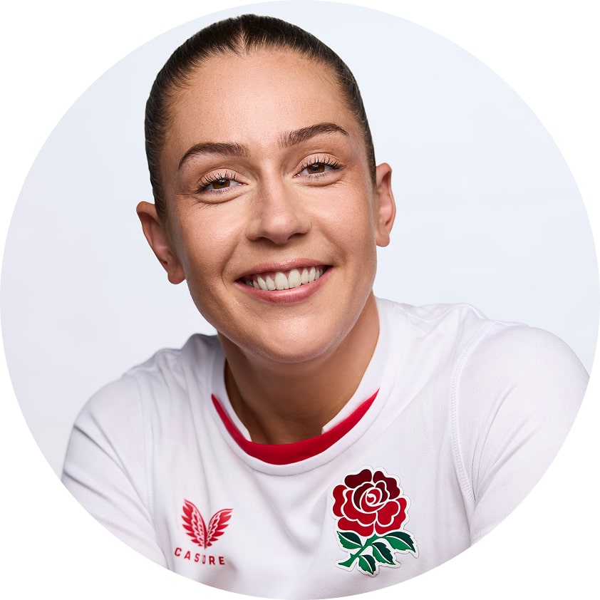 Headshot of Holly Aitchison, smiling in front of a bright white background