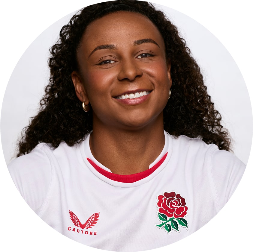 Headshot of Jade Shekells, smiling in front of a bright white background