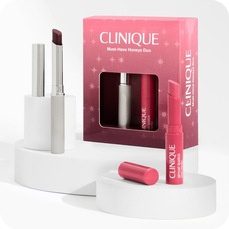 Selection of new and bestselling Clinique bodycare products on a grey plinth in a brightly lit studio setting