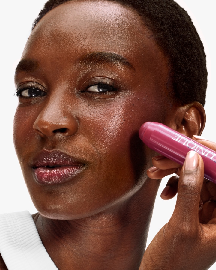 A close up shot of a model putting on a black honey lipstick 