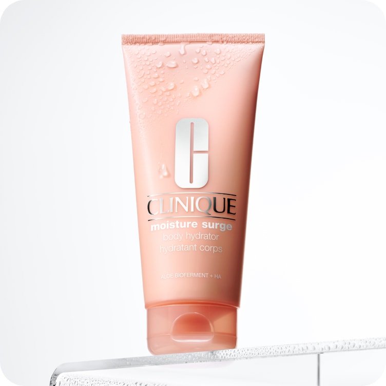 Woman with gray hair smelling Clinique perfume 