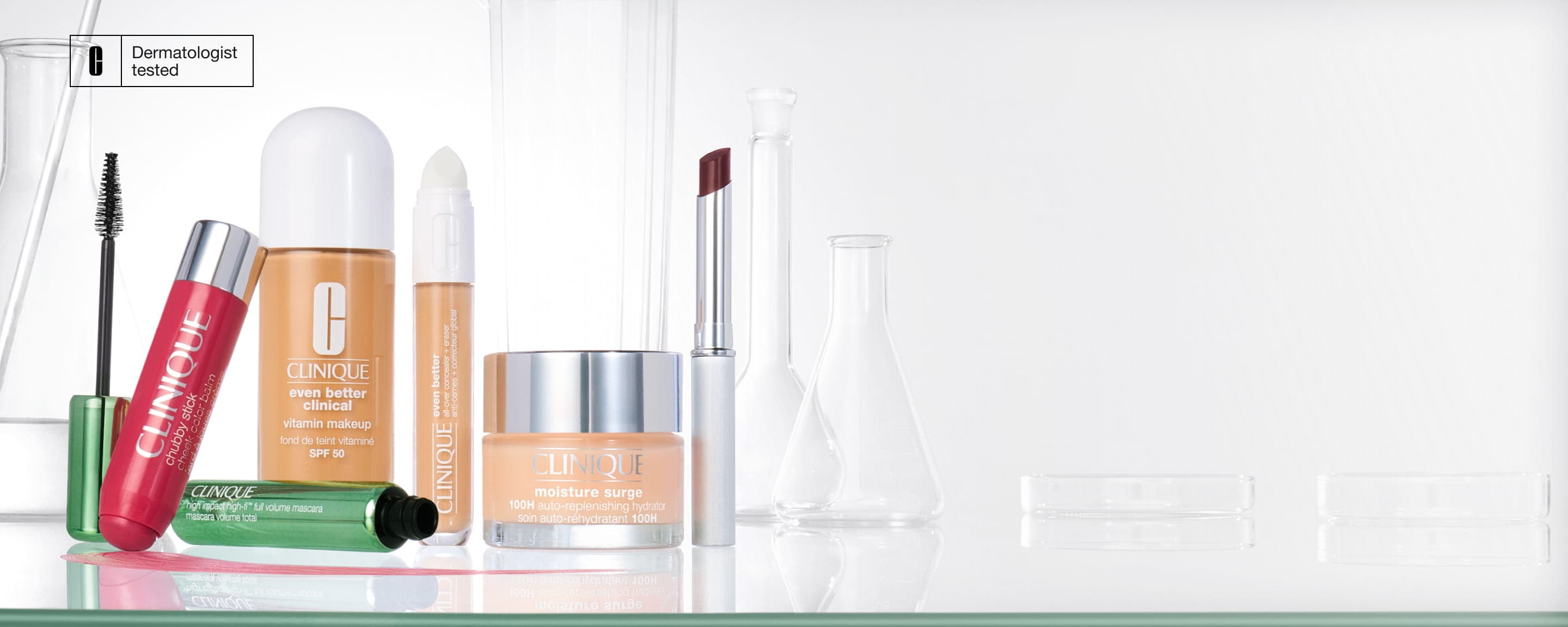 Selection of Clinique skincare and makeup products on a glass shelf, in a brightly lit lab setting