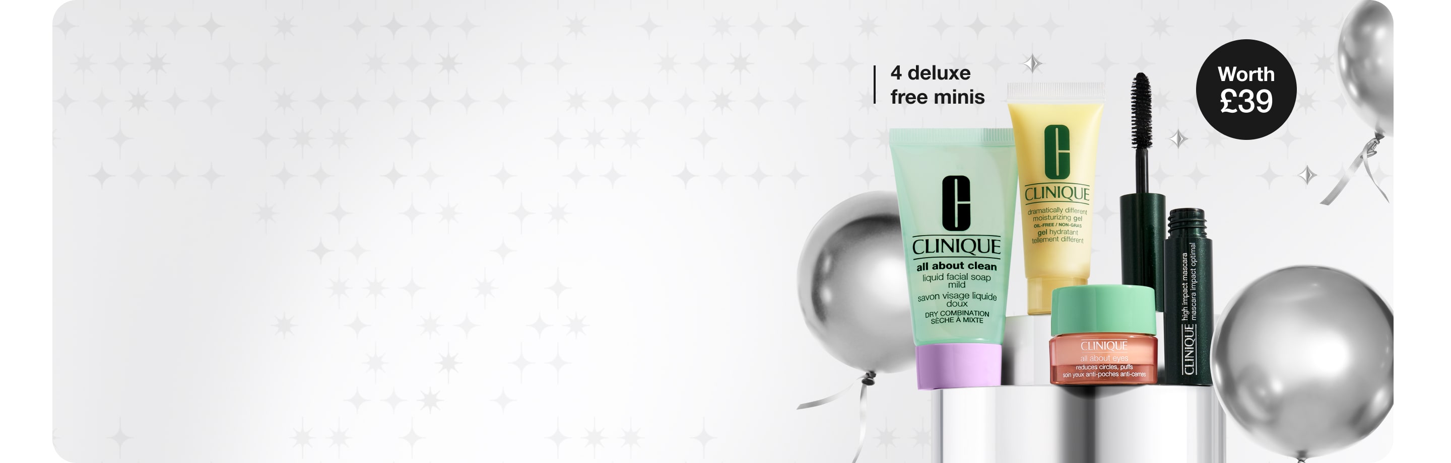 4 deluxe Clinique minis on a grey, metallic plinth, in a brightly lit setting, surrounded by decorative silver star graphics