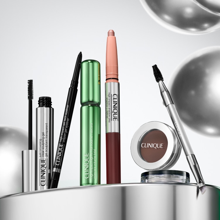 Selection of new brow and eye products dynamically placed on a glass shelf, in a brightly lit studio setting