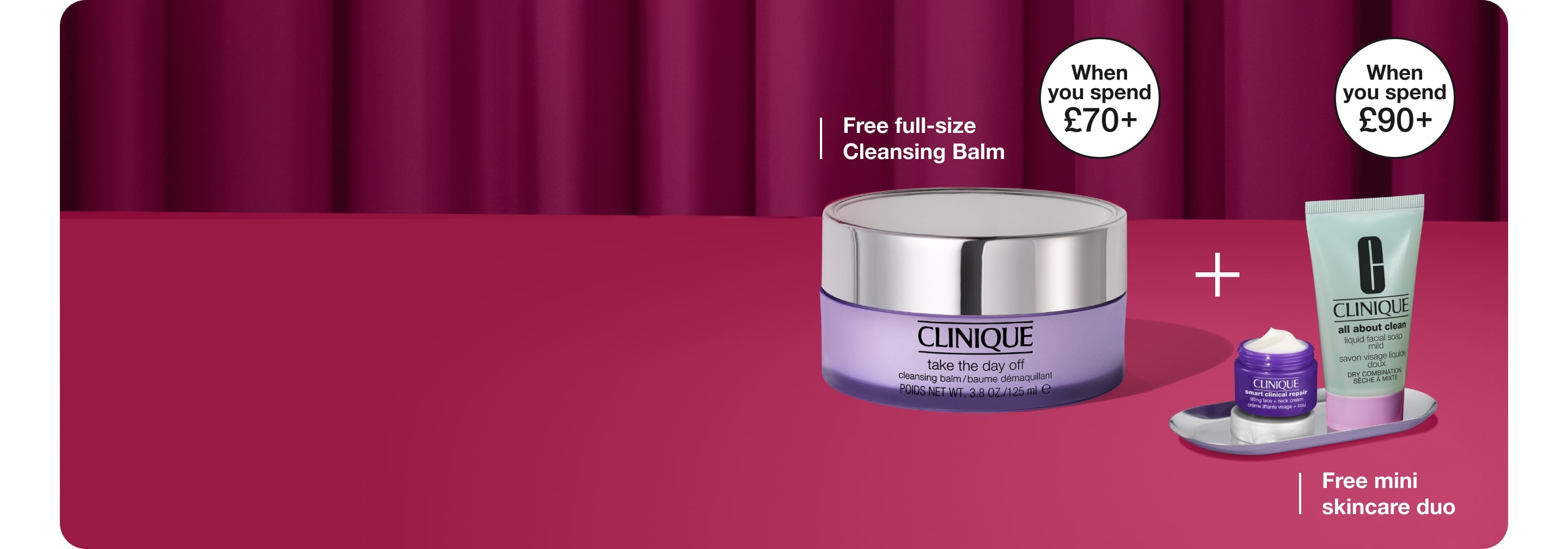 Full size Cleansing Balm and 2 deluxe minis in front of a bright purple curtain background