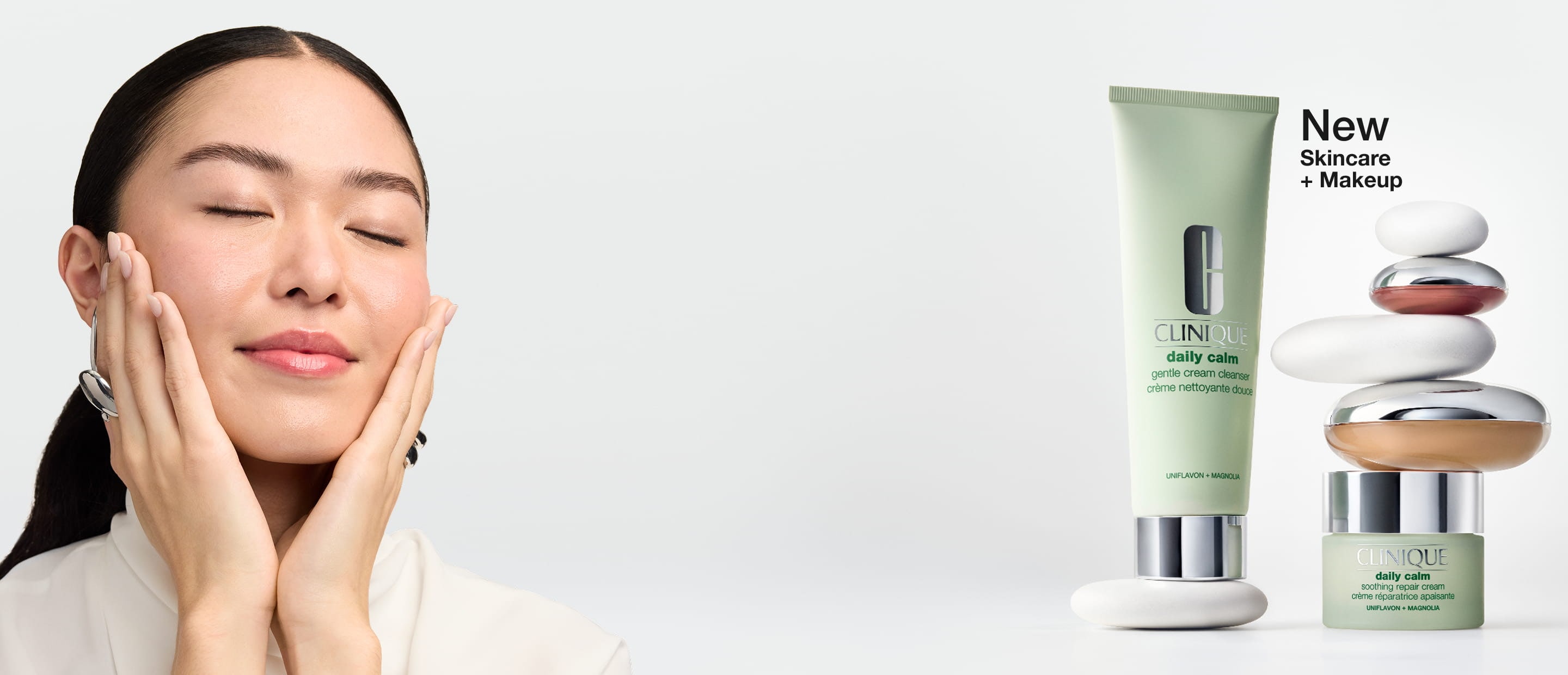Close up of model smiling, holding new UV Solutions mattifying sunscreen